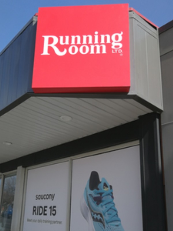 Running Room signage on a retail store in white lettering and a red background.